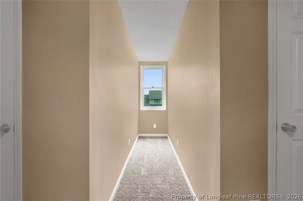 a view of a hallway with a white door