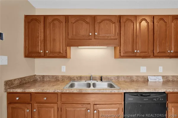 a kitchen with granite countertop stainless steel appliances a sink and cabinets
