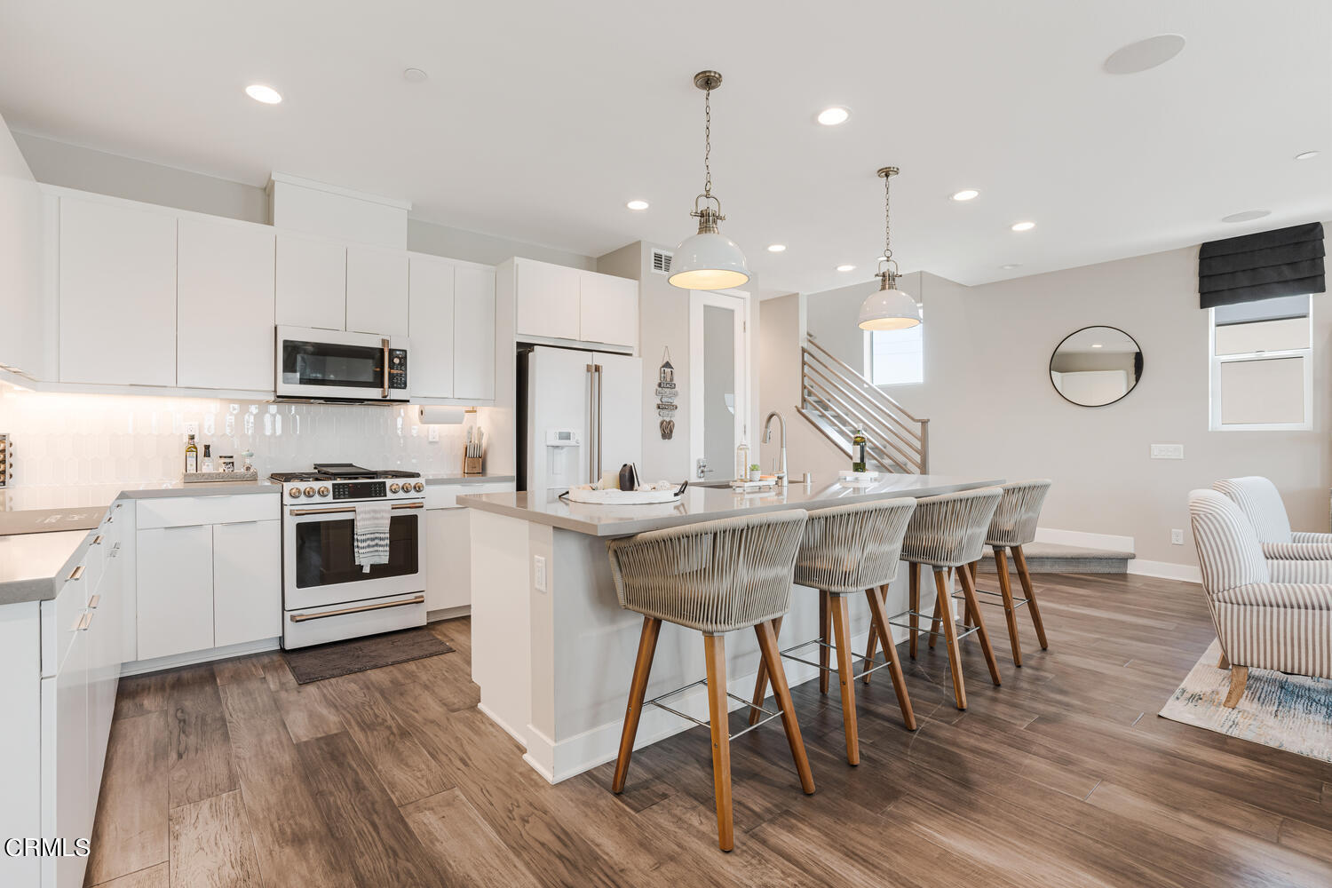 1028 Harbor Boulevard Oxnard, CA 93035 - Photo 14 of 48 a kitchen with a table chairs microwave and cabinets