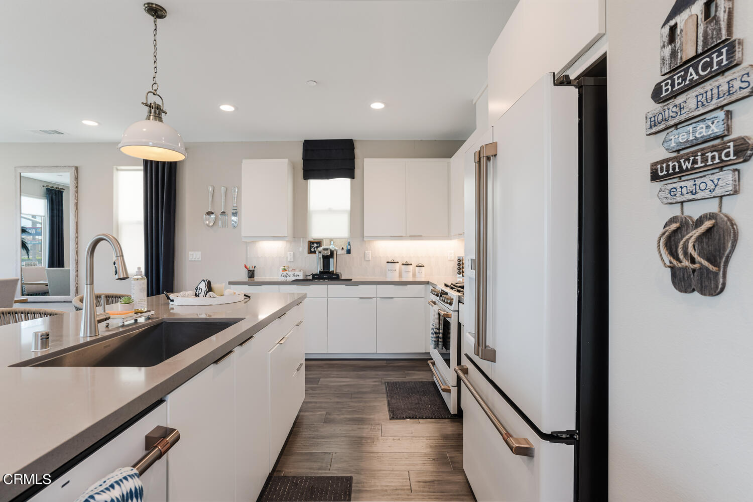 1028 Harbor Boulevard Oxnard, CA 93035 - Photo 21 of 48 a kitchen with white cabinets and sink