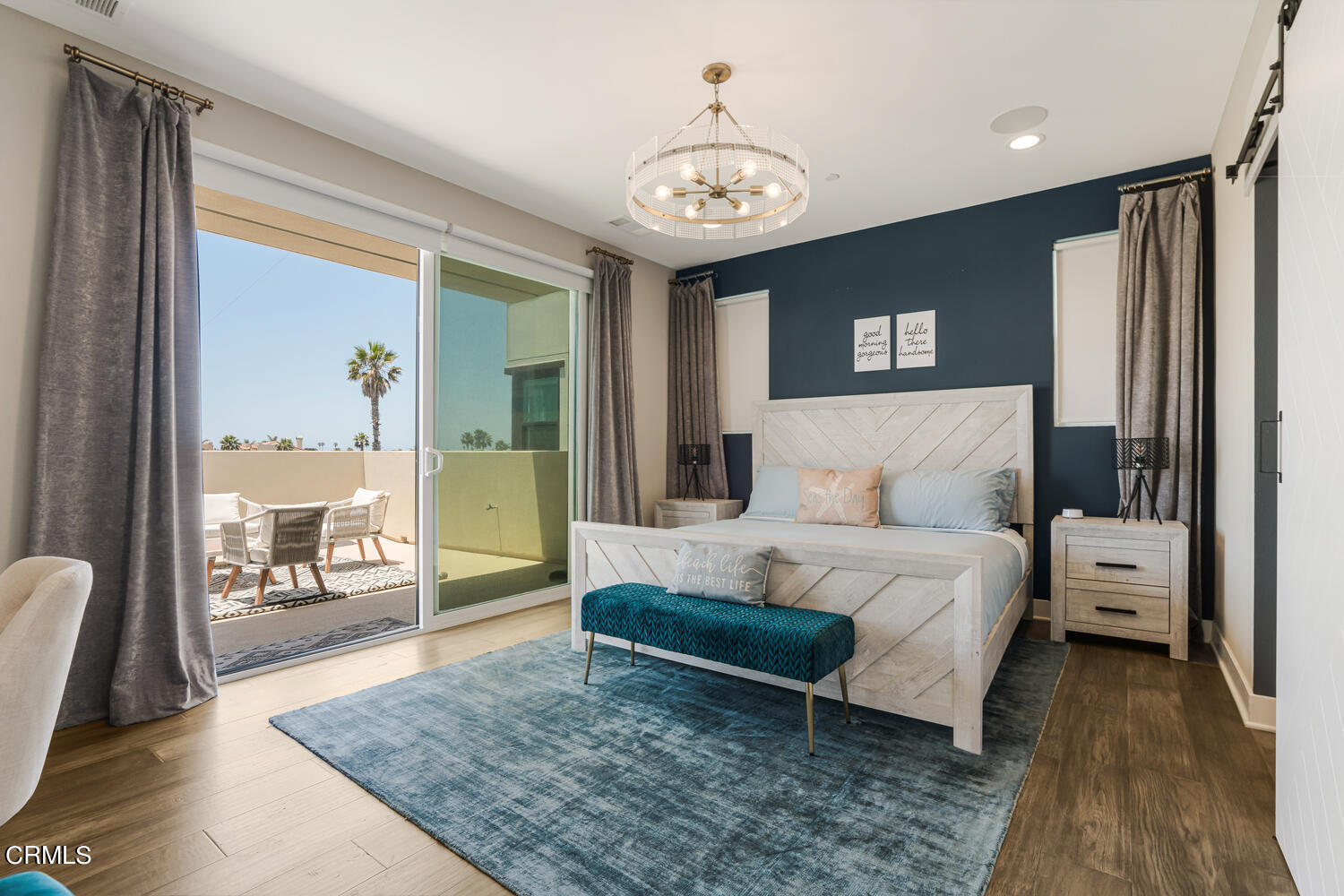 1028 Harbor Boulevard Oxnard, CA 93035 - Photo 23 of 48 a spacious bedroom with a bed a chandelier and a large window