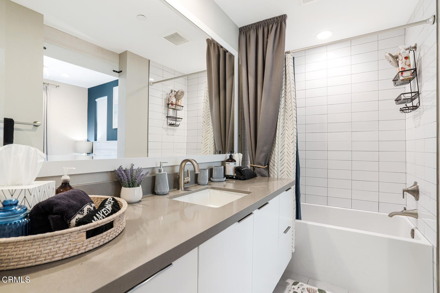 1028 Harbor Boulevard Oxnard, CA 93035 - Photo 34 of 48 a bathroom with a double vanity sink a mirror and a bathtub