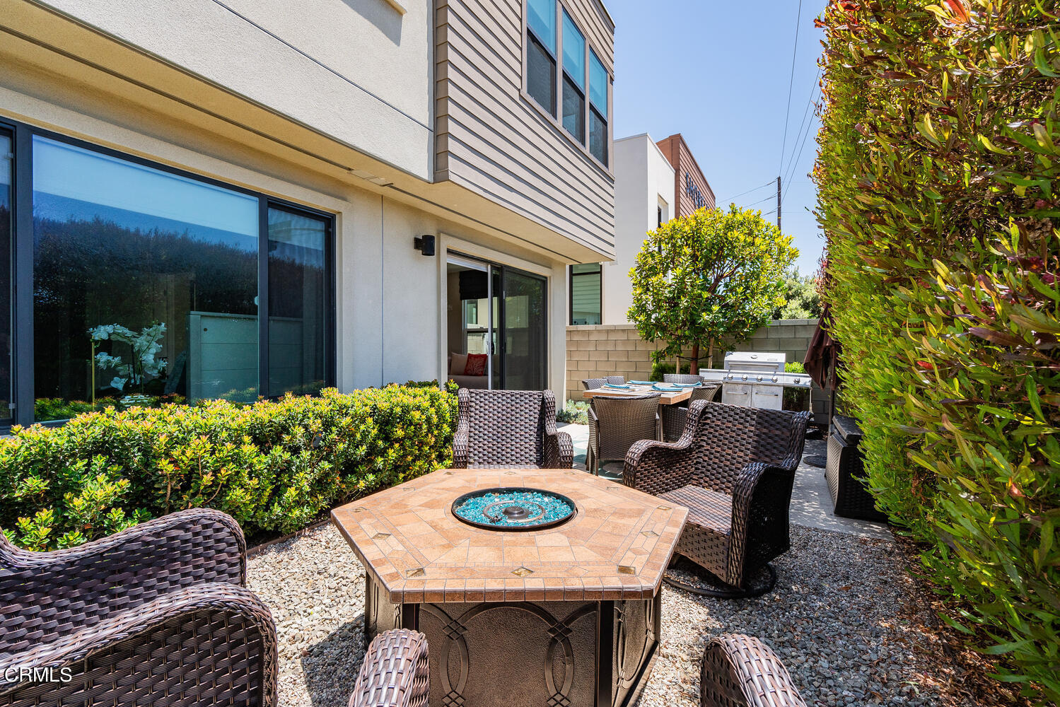 1028 Harbor Boulevard Oxnard, CA 93035 - Photo 40 of 48 a view of a patio with table and chairs potted plants and floor to ceiling window