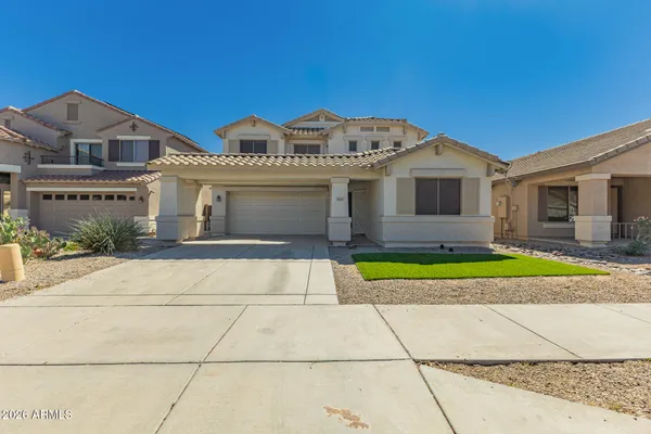 a front view of a house with a yard and garage