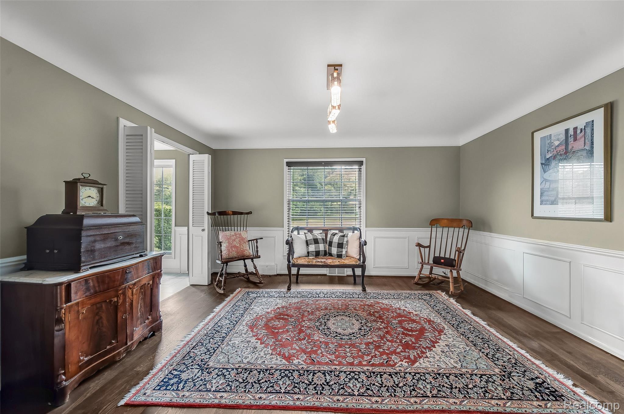 100 Overhill Road Bloomfield Hills, MI 48301 - Photo 12 of 55 Living area with wainscoting, dark wood-style flooring, and a decorative wall