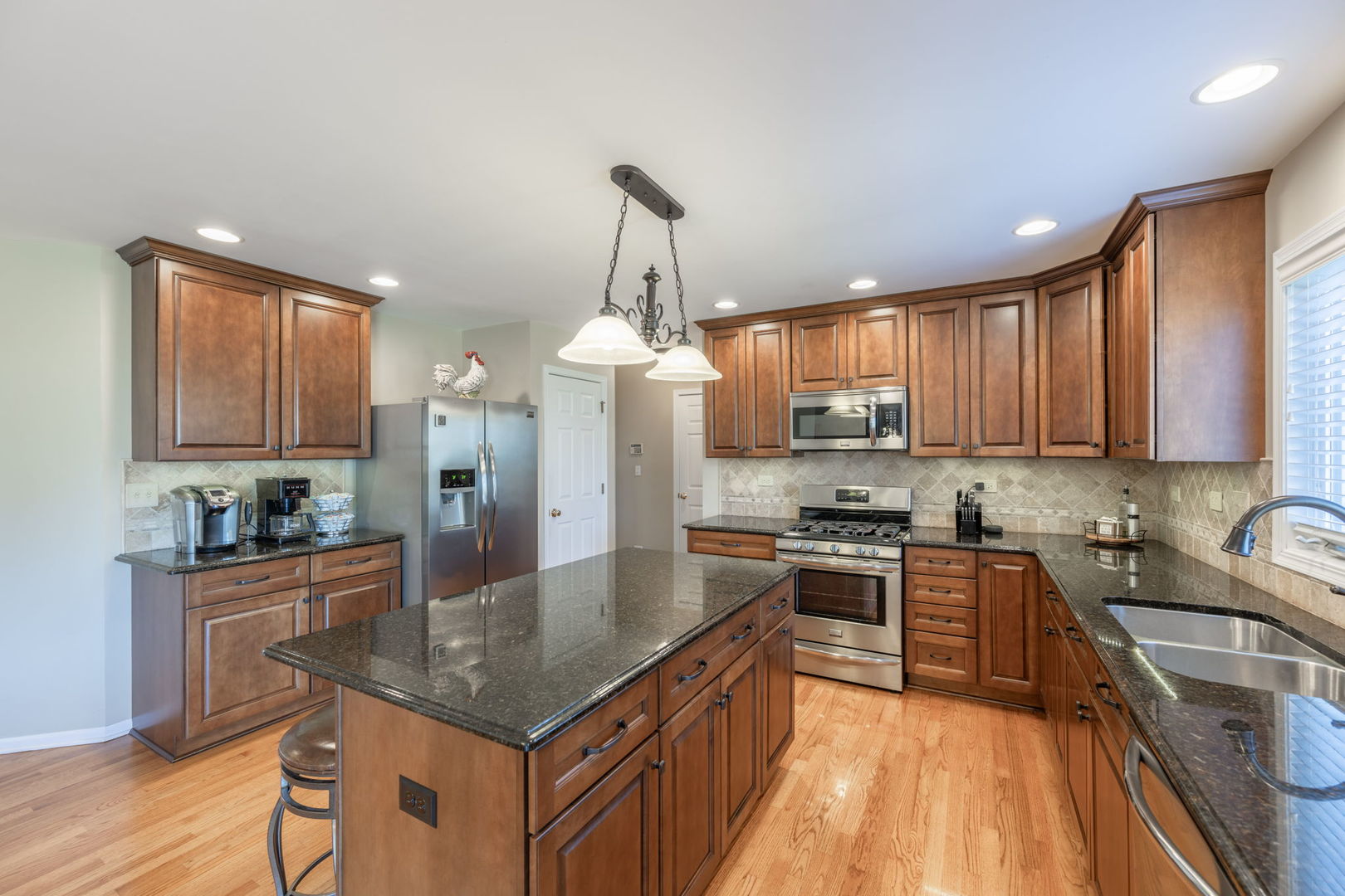 3040 Wagner Road Aurora, IL 60502 - Photo 10 of 37 a kitchen with stainless steel appliances granite countertop a sink stove and refrigerator