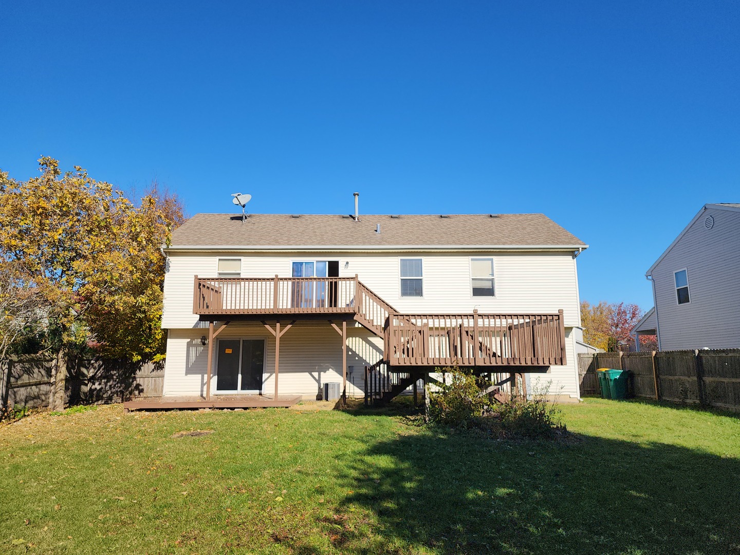5216 Riviera Boulevard Plainfield, IL 60586 - Photo 11 of 14 a front view of a house with a garden and yard