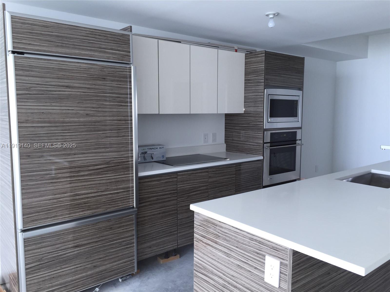 460 Northeast 28th Street, Unit 3707 Miami, FL 33137 - Photo 2 of 12 a kitchen with a cabinets and stainless steel appliances