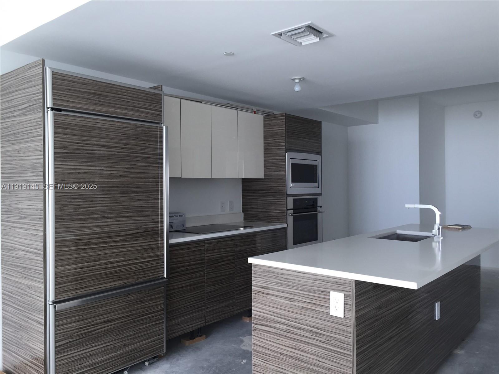 460 Northeast 28th Street, Unit 3707 Miami, FL 33137 - Photo 3 of 12 a kitchen with a sink and cabinets