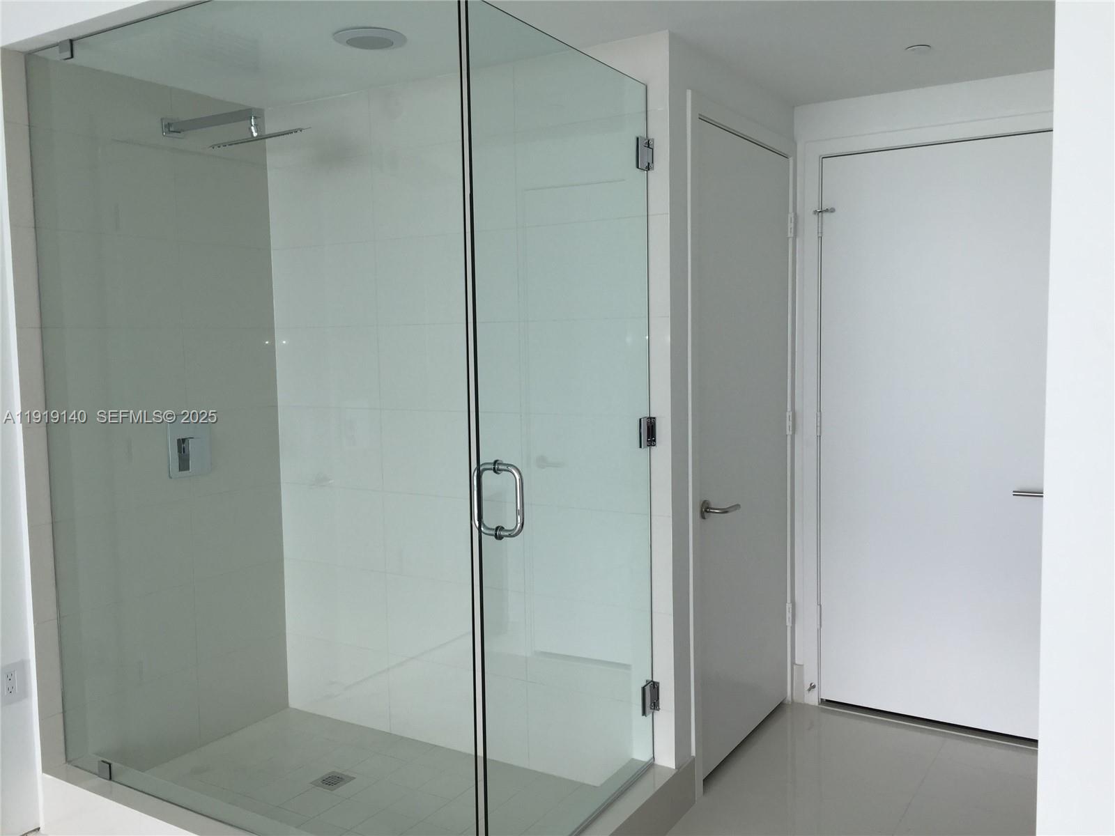 460 Northeast 28th Street, Unit 3707 Miami, FL 33137 - Photo 6 of 12 a bathroom with a glass shower door