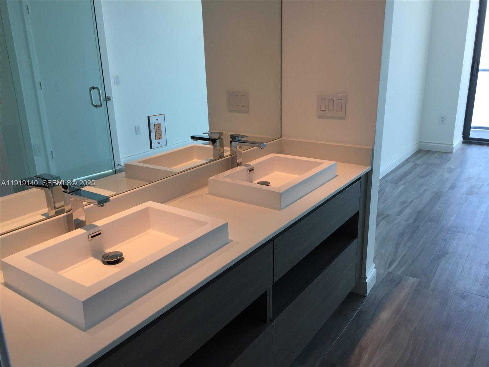 460 Northeast 28th Street, Unit 3707 Miami, FL 33137 - Photo 7 of 12 a bathroom with a sink and a mirror