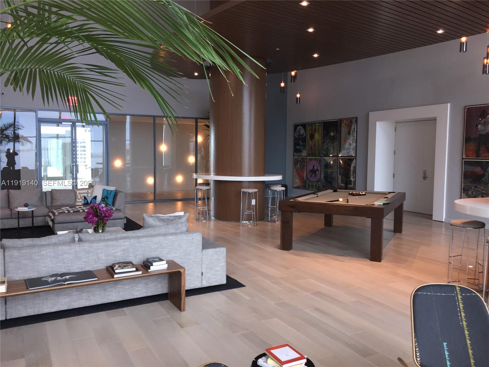 460 Northeast 28th Street, Unit 3707 Miami, FL 33137 - Photo 10 of 12 a room with furniture a wooden floor and potted plant