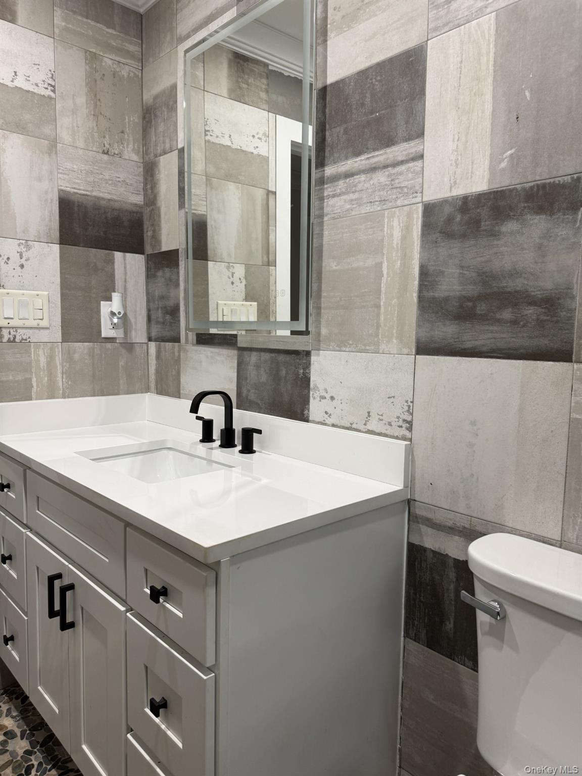 11 Bayview Avenue Lawrence, NY 11559 - Photo 17 of 18 a bathroom with a sink and a toilet