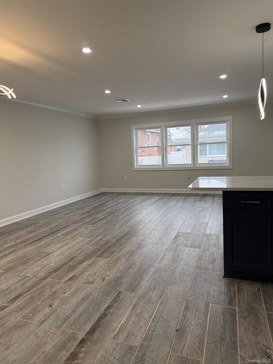 11 Bayview Avenue Lawrence, NY 11559 - Photo 7 of 18 an empty room with wooden floor and windows