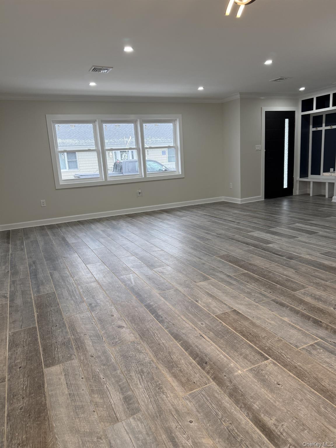11 Bayview Avenue Lawrence, NY 11559 - Photo 8 of 18 an empty room with wooden floor and windows