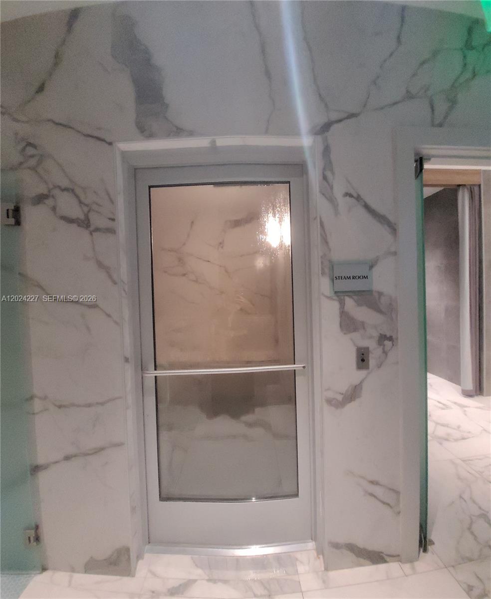 90 Southwest 3rd Street, Unit 2208 Miami, FL 33130 - Photo 40 of 56 a bathroom with a glass shower door and a window