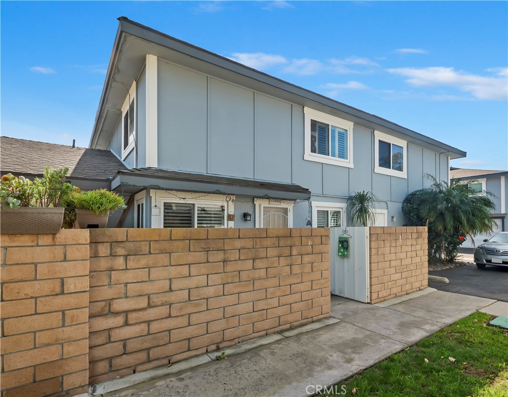 16406 Vista Roma Circle, Unit 115 Huntington Beach, CA 92649 - Photo 19 of 26 a brick building with a bench in front of it