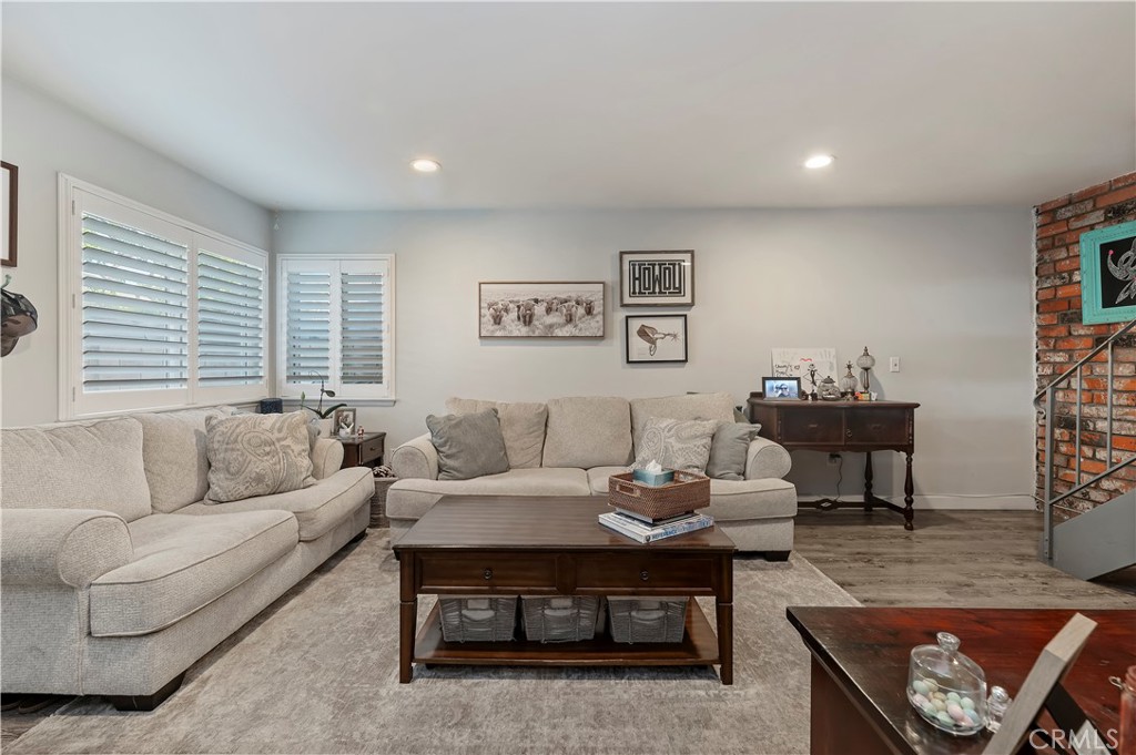 16406 Vista Roma Circle, Unit 115 Huntington Beach, CA 92649 - Photo 2 of 26 a living room with furniture and a window