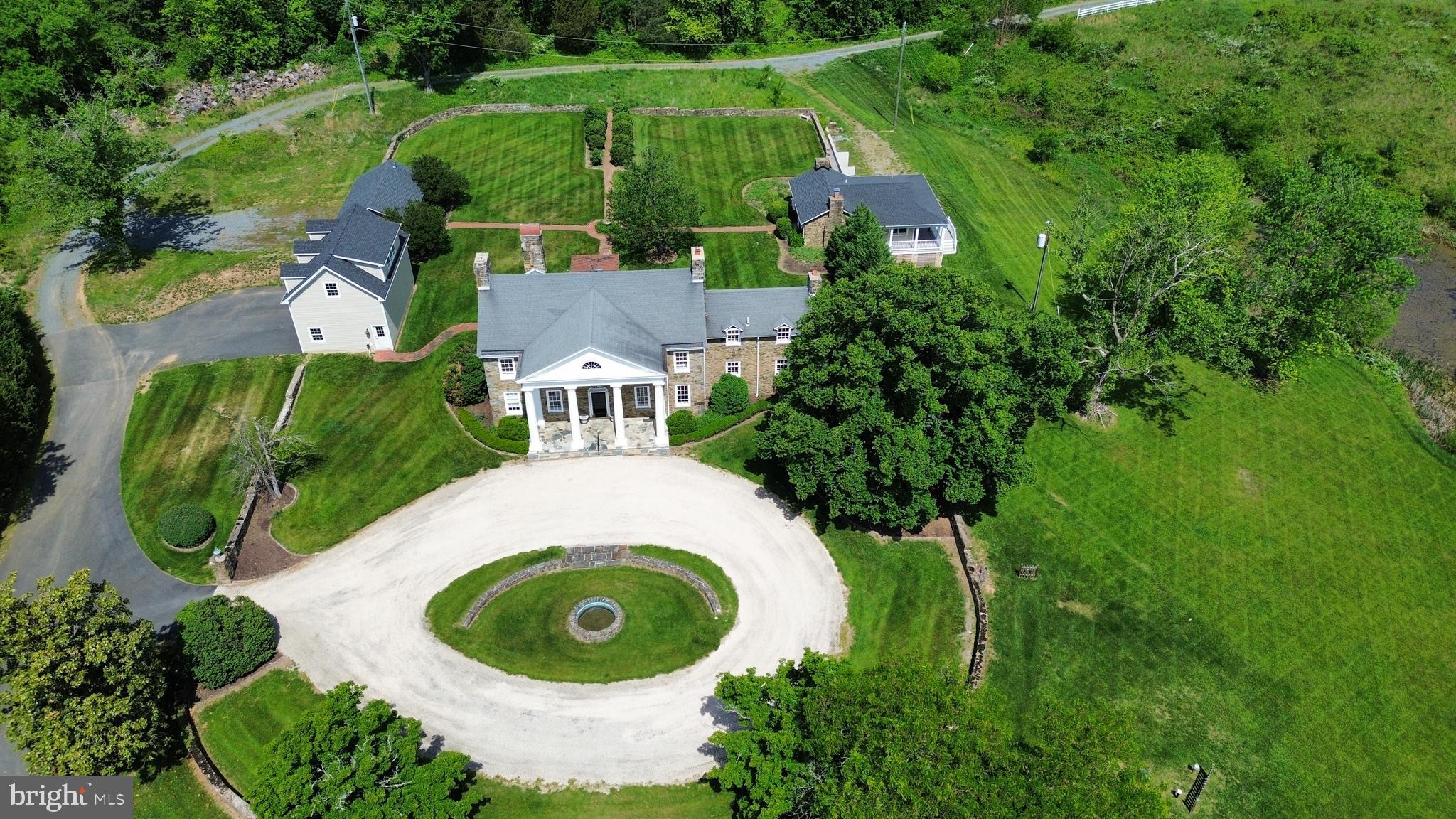 17781 Roxbury Hall Road Leesburg, VA 20175 - Photo 5 of 107 an aerial view of a house with outdoor space and a lake view
