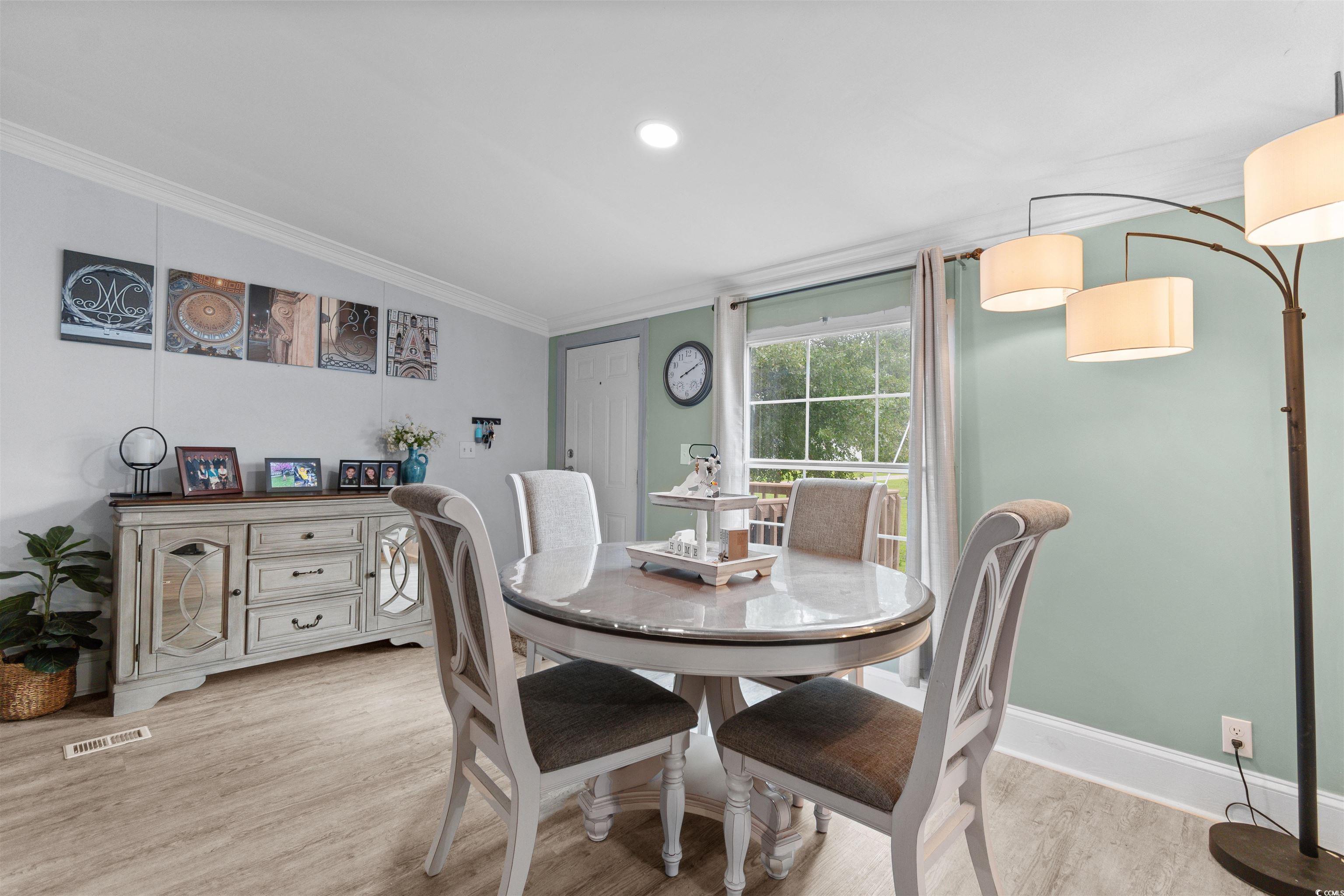 11140 Mcdowell Shortcut Road Murrells Inlet, SC 29576 - Photo 14 of 33 Dining room featuring vaulted ceiling, light wood-style floors, ornamental molding, and recessed lighting