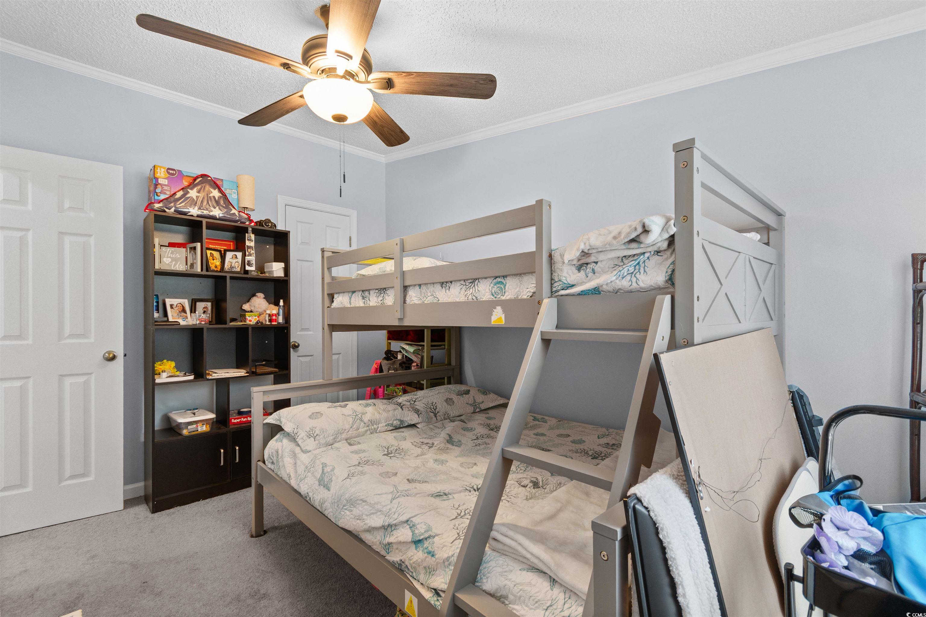 11140 Mcdowell Shortcut Road Murrells Inlet, SC 29576 - Photo 19 of 33 Bedroom featuring ornamental molding, carpet, a textured ceiling, and ceiling fan