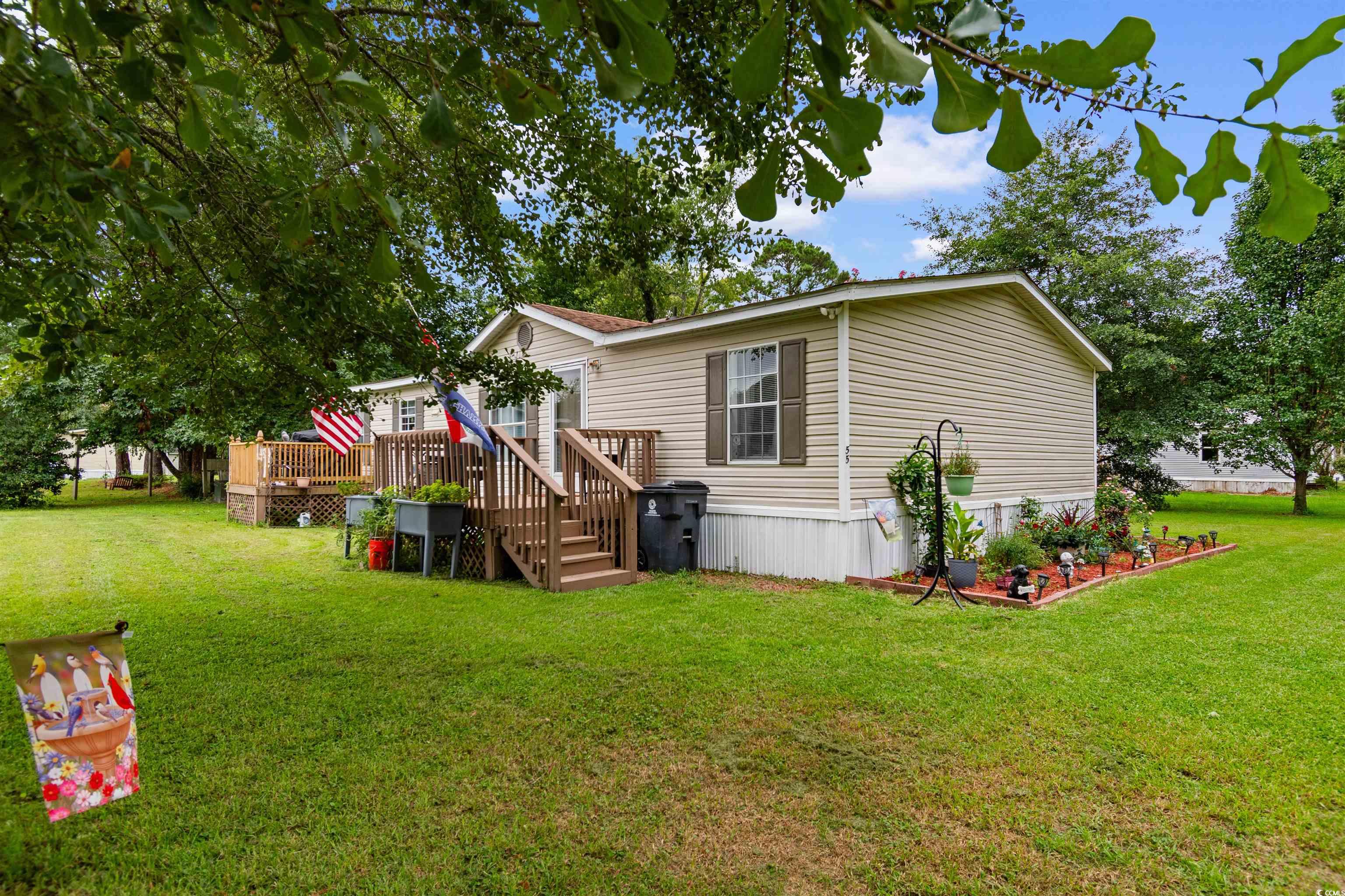 11140 Mcdowell Shortcut Road Murrells Inlet, SC 29576 - Photo 2 of 33 View of side of property with a deck and a yard