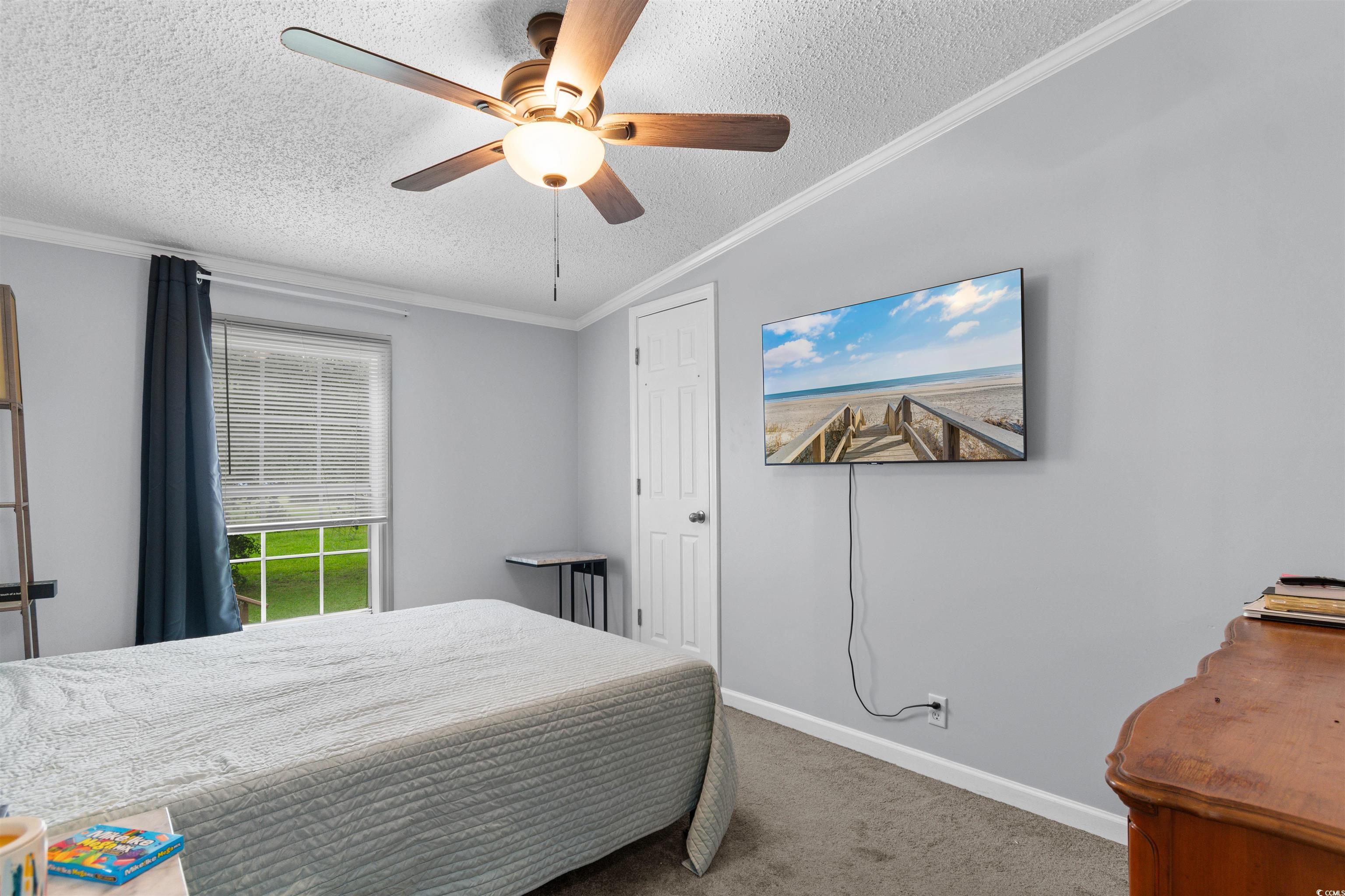 11140 Mcdowell Shortcut Road Murrells Inlet, SC 29576 - Photo 22 of 33 Carpeted bedroom featuring ornamental molding, a textured ceiling, and ceiling fan