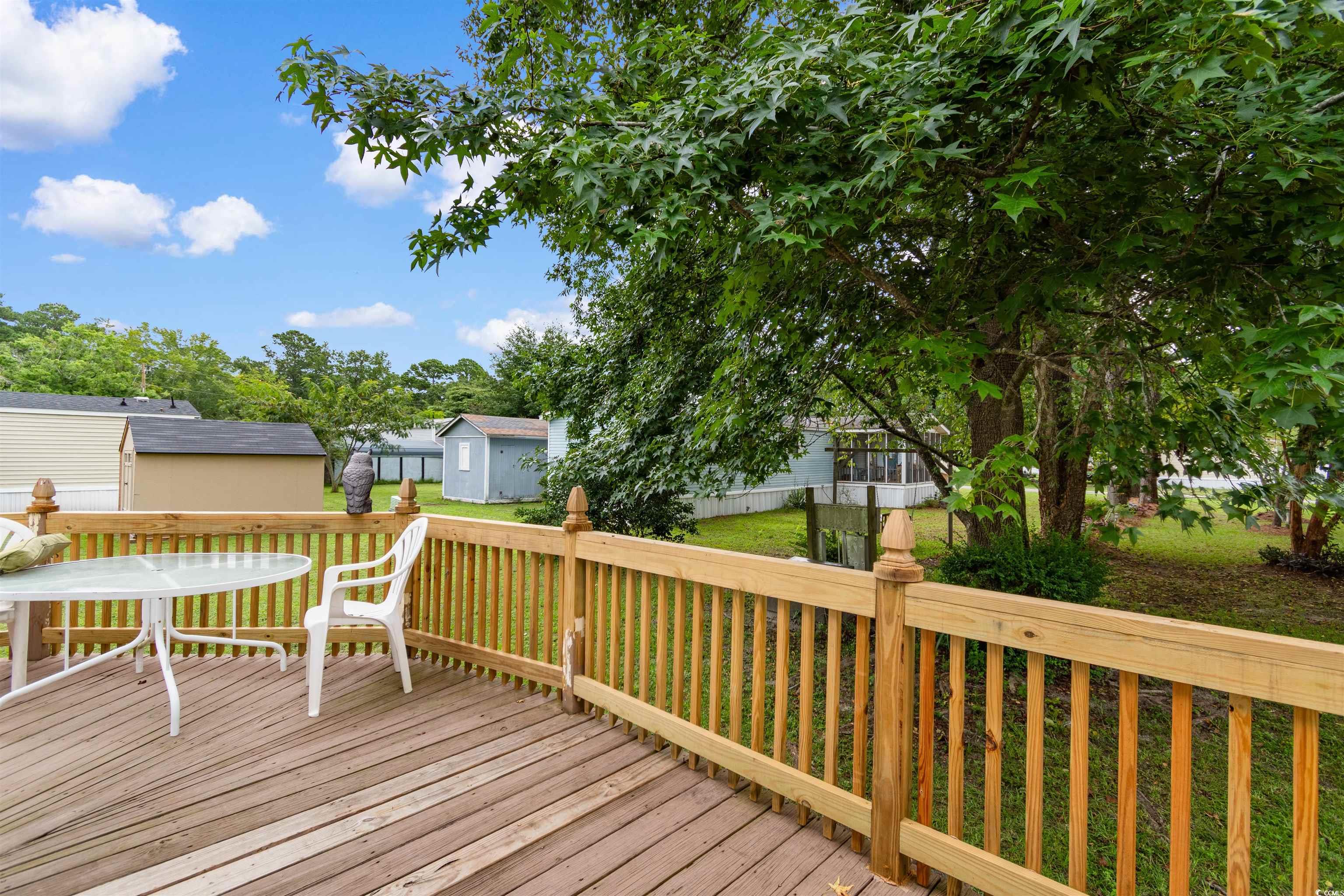 11140 Mcdowell Shortcut Road Murrells Inlet, SC 29576 - Photo 25 of 33 Wooden deck featuring a yard and a storage shed