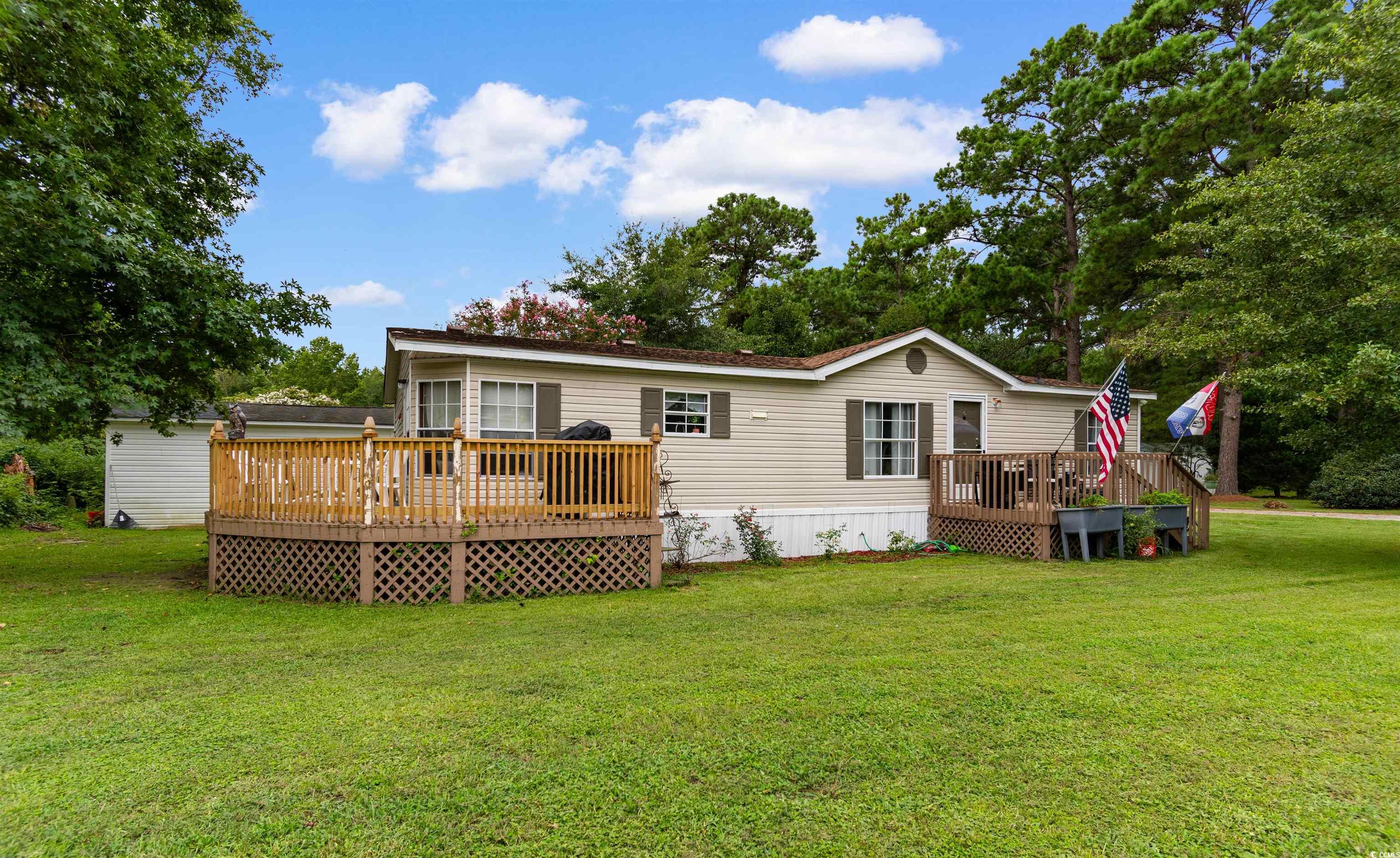 11140 Mcdowell Shortcut Road Murrells Inlet, SC 29576 - Photo 29 of 33 Rear view of property featuring a deck, a yard, and view of scattered trees