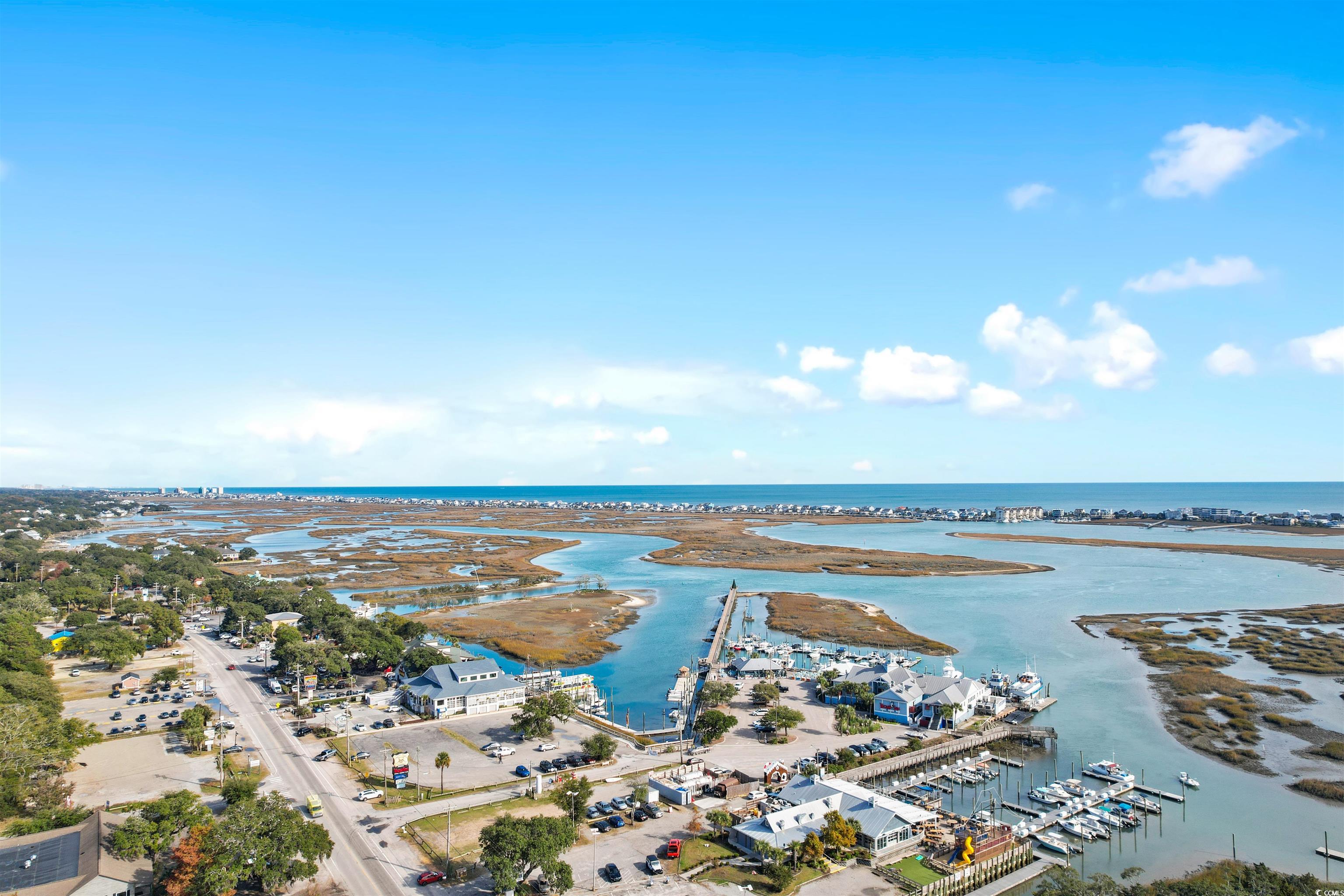 11140 Mcdowell Shortcut Road Murrells Inlet, SC 29576 - Photo 31 of 33 Drone / aerial view of a large body of water, numerous boat docks, and a notable bridge
