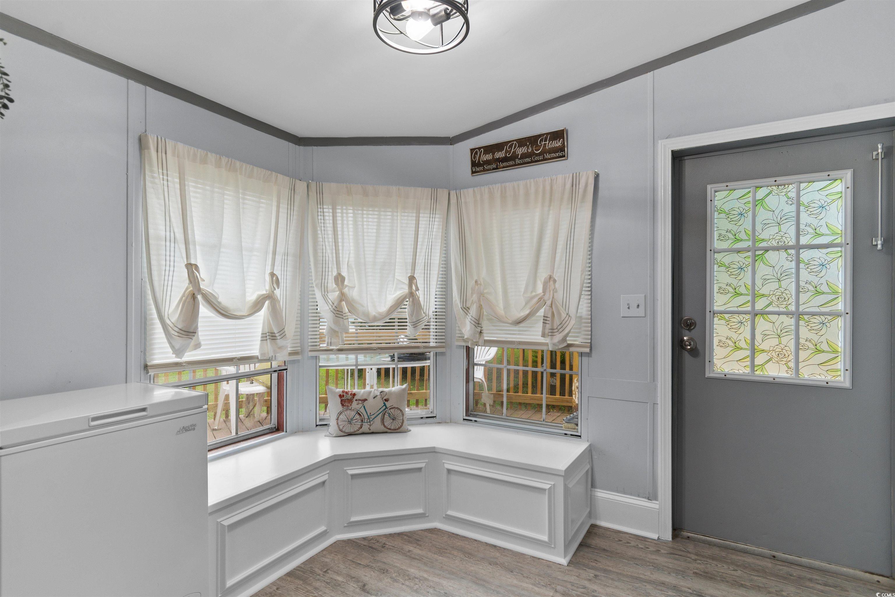 11140 Mcdowell Shortcut Road Murrells Inlet, SC 29576 - Photo 10 of 33 Interior space with light wood-style floors, a decorative wall, and ornamental molding
