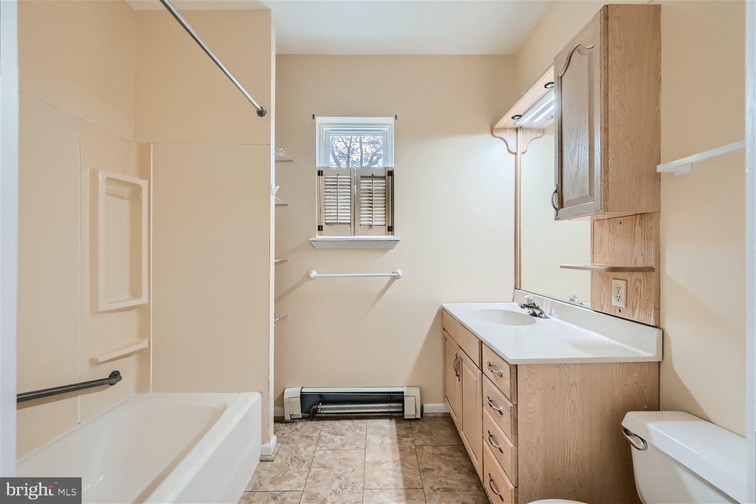 716 South Camp Meade Road, Unit A Linthicum Heights, MD 21090 - Photo 7 of 11 a bathroom with a double vanity sink a toilet and a bathtub