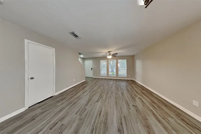 wooden floor in an empty room with a window