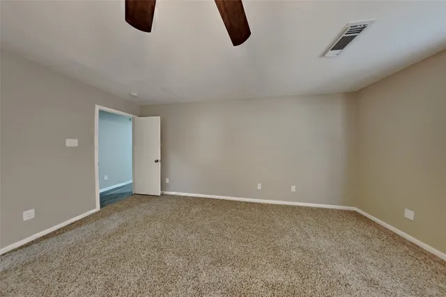 a view of an empty room with windows