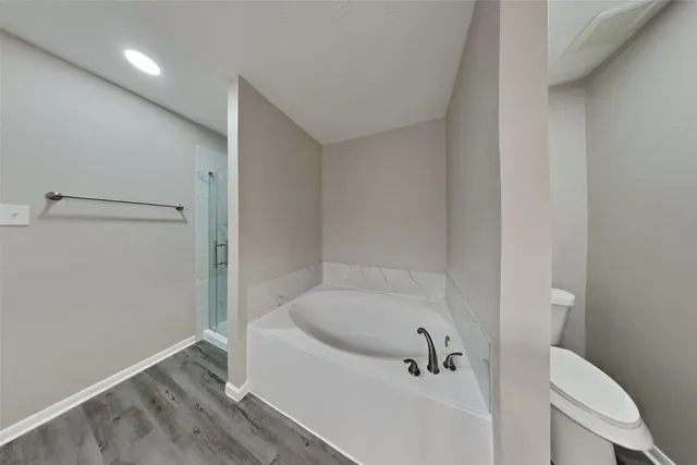a white bath tub sitting next to a white toilet