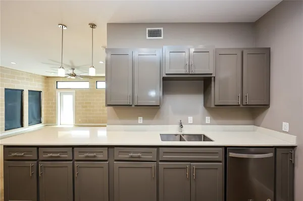 a kitchen with a sink and refrigerator