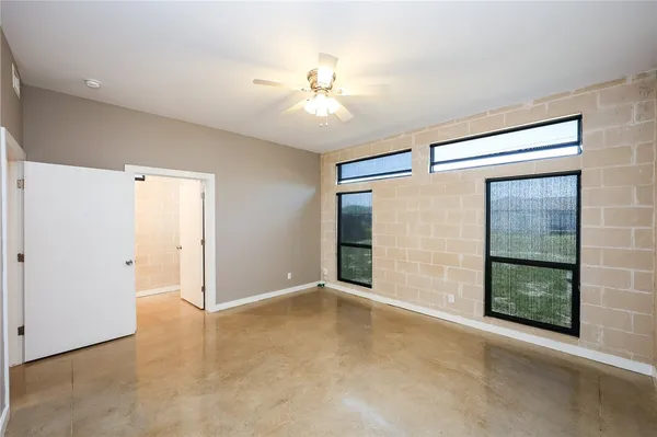 an empty room with windows and entrance