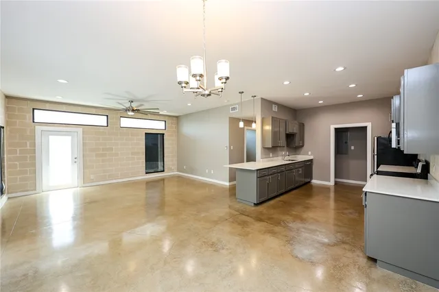 a large kitchen with kitchen island a sink stainless steel appliances and cabinets