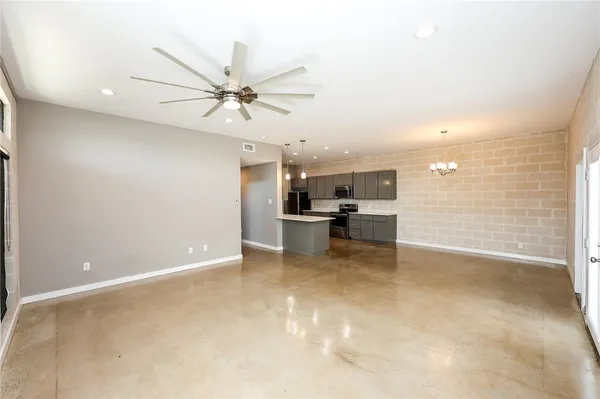 a view of a kitchen with a sink and a refrigerator