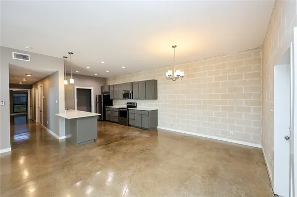 a large kitchen with a sink and cabinets
