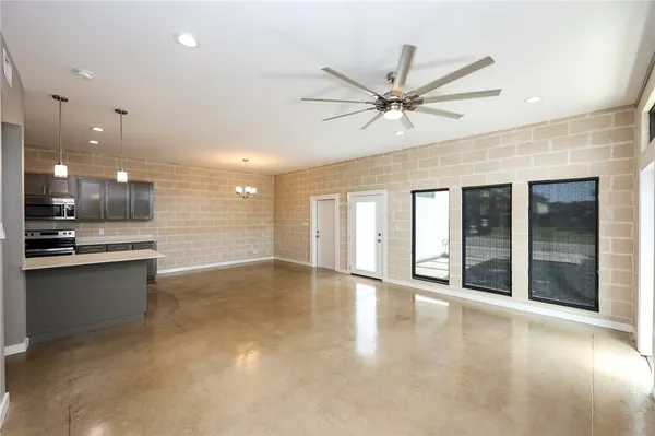 a view of an empty room with window and cabinet