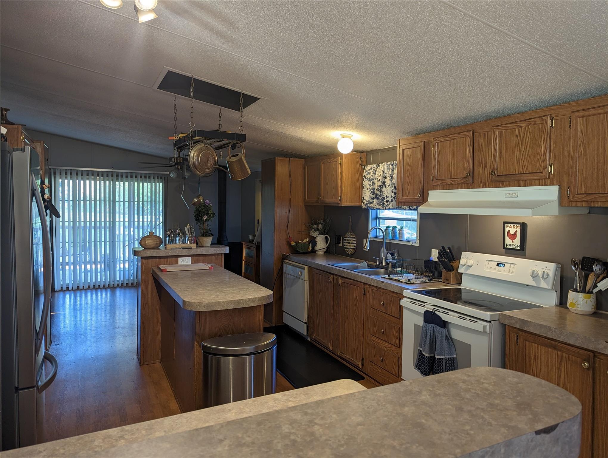 21824 Joy Road Locust, NC 28097 - Photo 9 of 24 a kitchen with stainless steel appliances granite countertop a sink stove and refrigerator