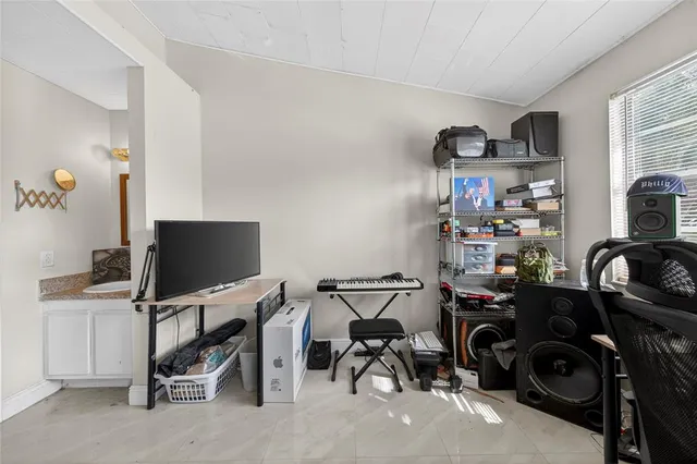 a view of a workspace with furniture and a window
