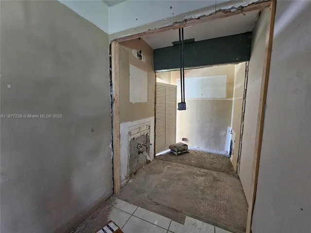 a view of a big room with wooden floor and windows