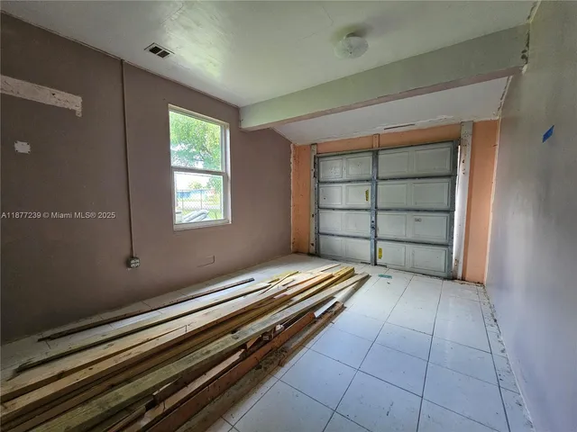 a room with a bunk bed and a window