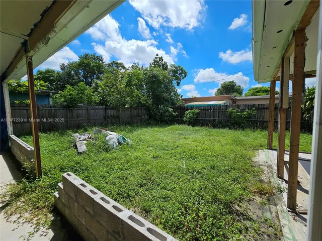 a view of backyard with garden and entertaining space