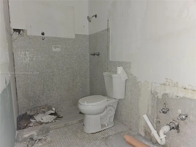 a bathroom with a toilet sink and shower