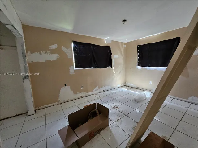 a living room with hard wood floor and a flat screen tv