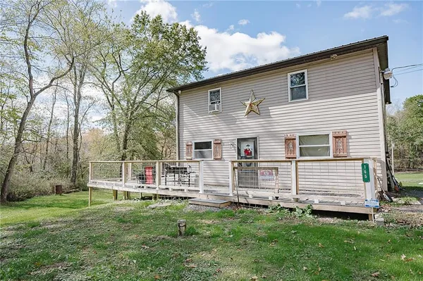 a view of a house with a backyard