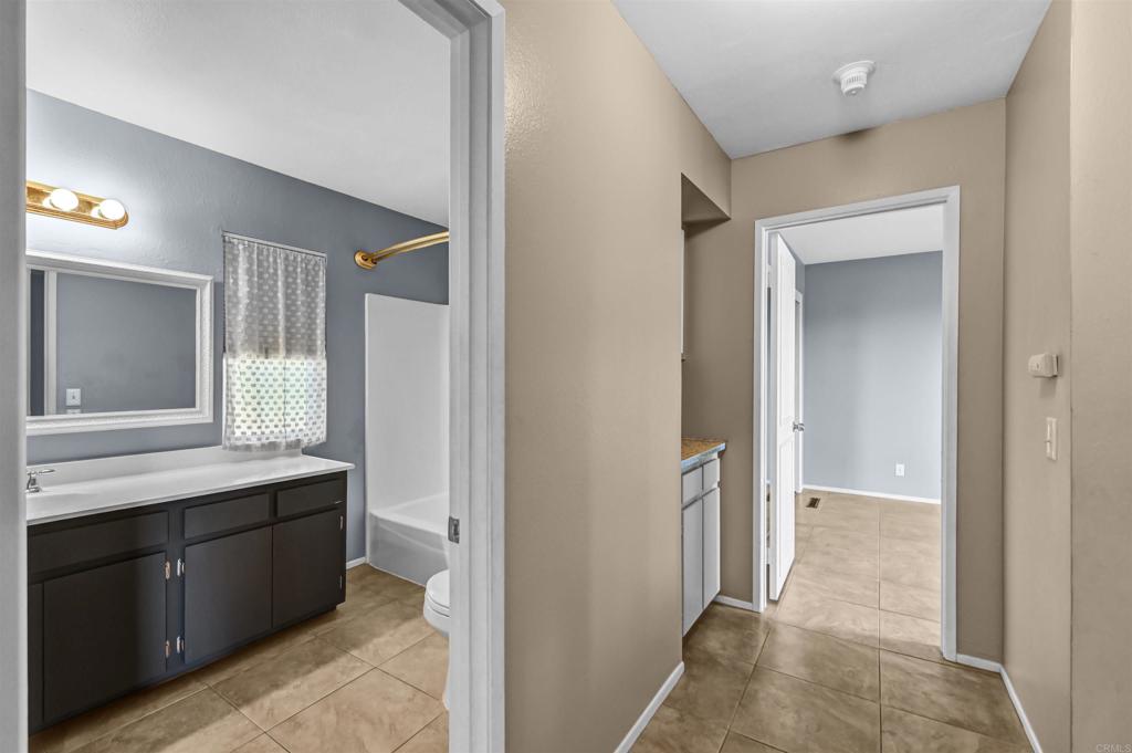 735 South Upas Street Escondido, CA 92025 - Photo 17 of 28 a bathroom with a sink a toilet and a large mirror